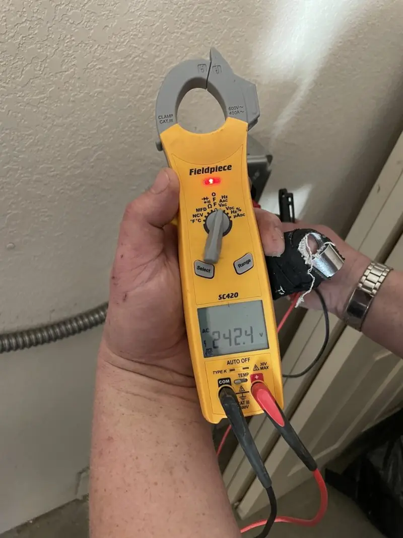 Voltage testing with clamp meter during Whole House Surge Protector in Perry